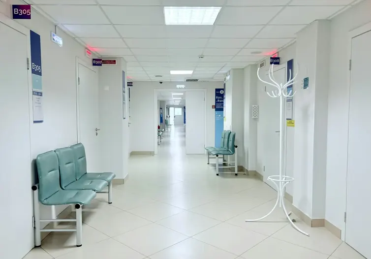 Clean hospital corridor with waiting chairs