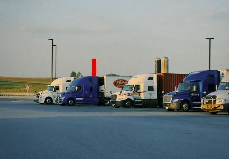Row of parked semi-trucks at a freight yard
