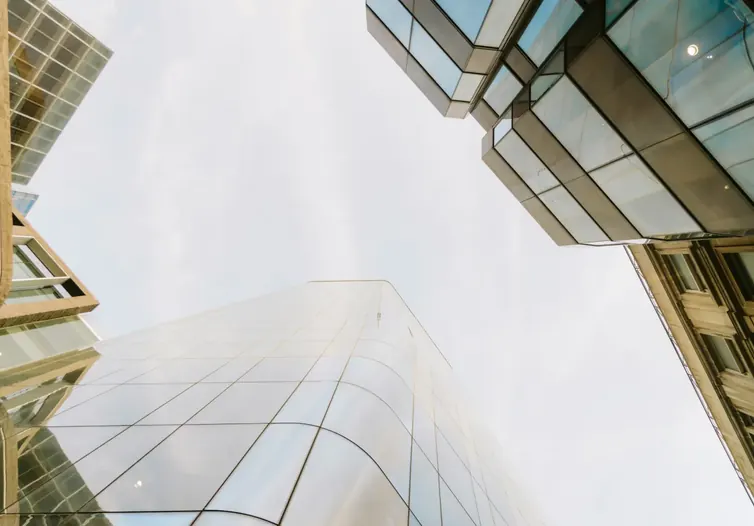 Glass office towers seen from street level looking up