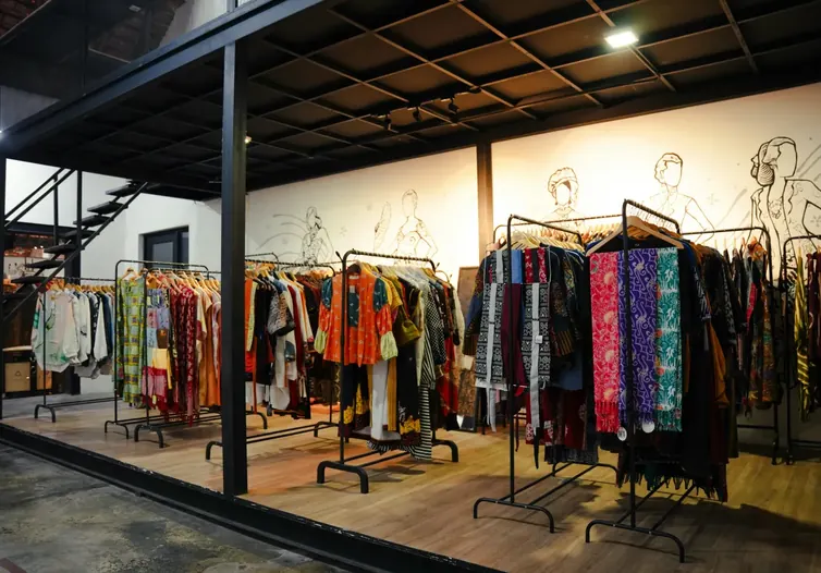 Clothing store with colorful garments on rails