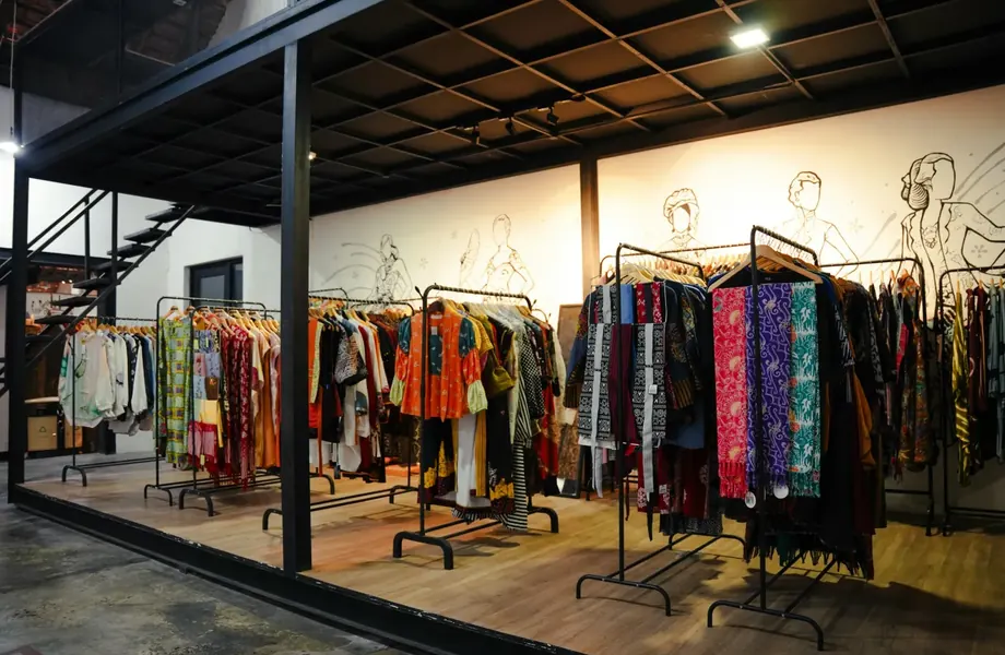 Clothing store with colorful garments on rails