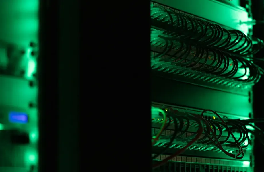 Server rack with network cables lit in green