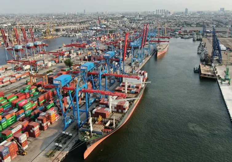Aerial view of a container port with ships, cranes and stacked containers