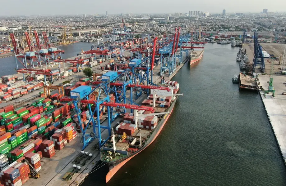 Aerial view of a container port with ships, cranes and stacked containers